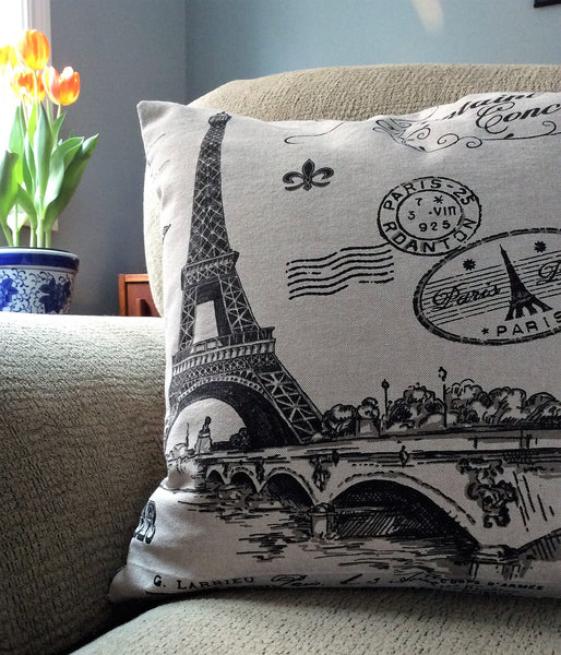 Paris print accent cushion in tan with black images and zippered closure