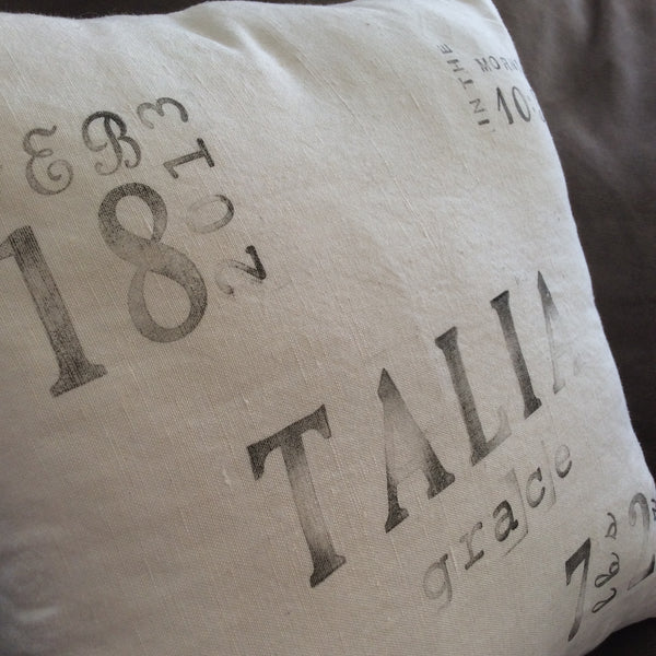 ivory linen ink-stamped birth announcement pillow close up
