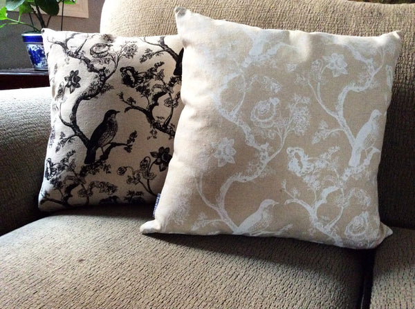 Tan accent cushions with white or black bird and flower images