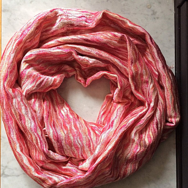 pink and coral subtle wave patterned infinity scarf flatlay image