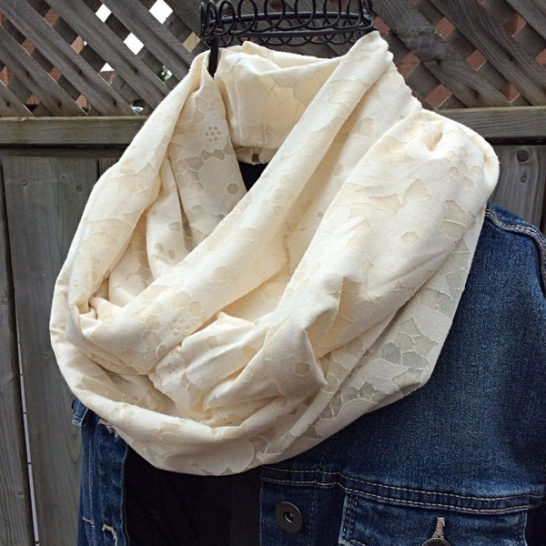 ivory infinity scarf with flower burnout effect worn with jean jacket