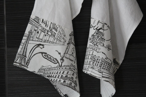 White linen dish towels with black Parisian images, close-up of images