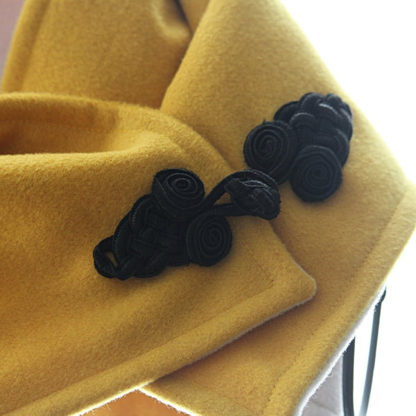 golden yellow and ivory neck wrap with black frog fastener detail