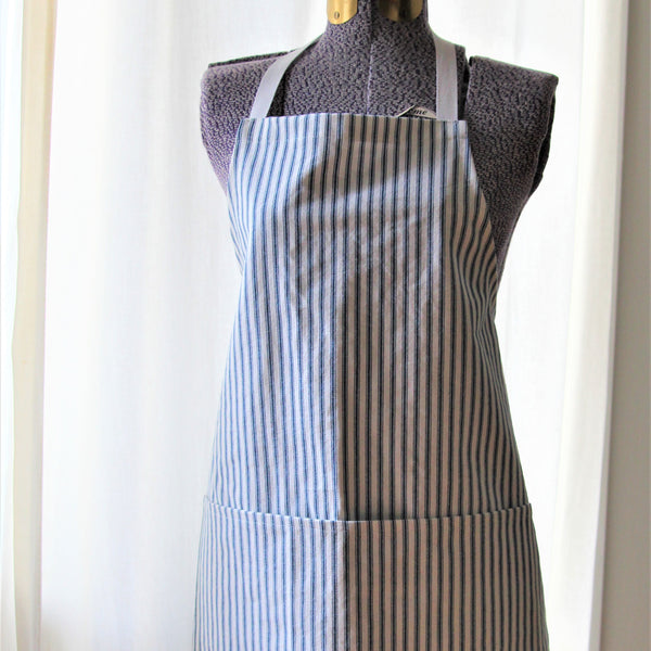 Full apron in white with navy blue ticking stripe displayed on a mannequin