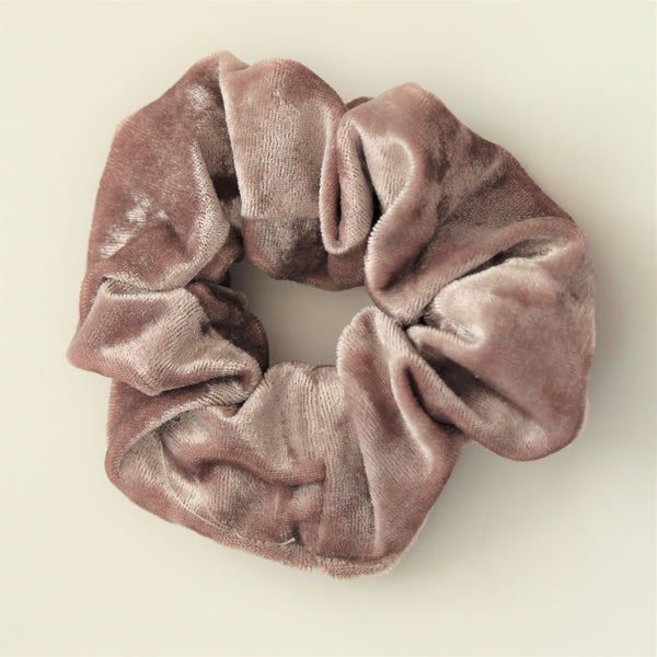 Mink/dusty lilac coloured velvet hair scrunchie on a white surface