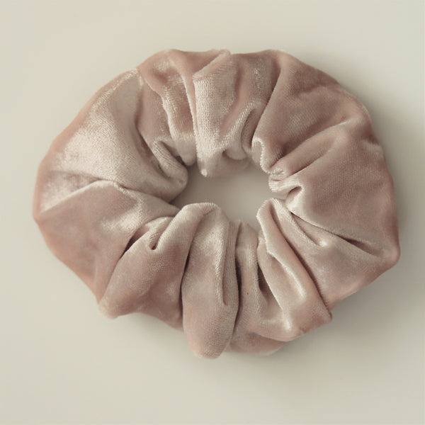 Pearl/oyster coloured velvet hair scrunchie on a white surface