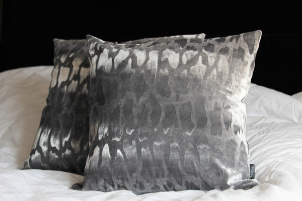 silver velvet accent cushion with embossed motif