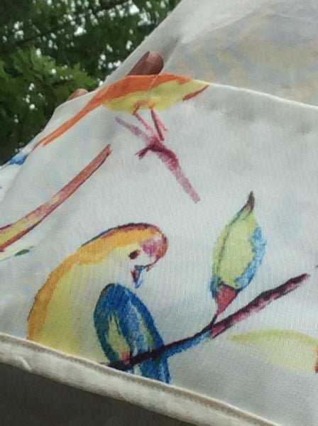 garden apron with colourful bird print close-up