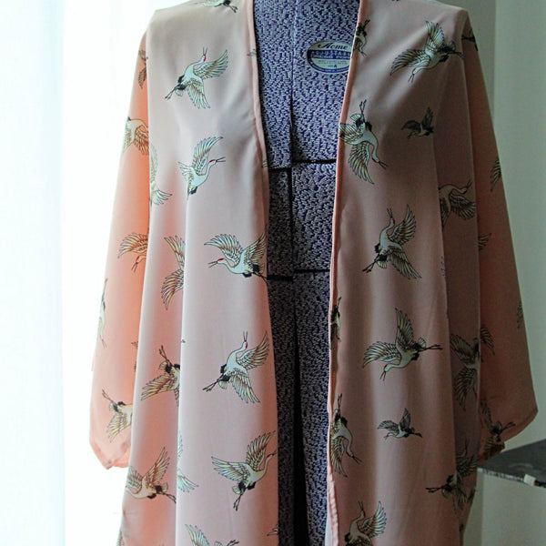 Light pink kimono cardigan with flying cranes front view