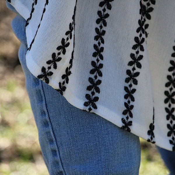 white kimono cardigan with black embroidered stripes hem detail